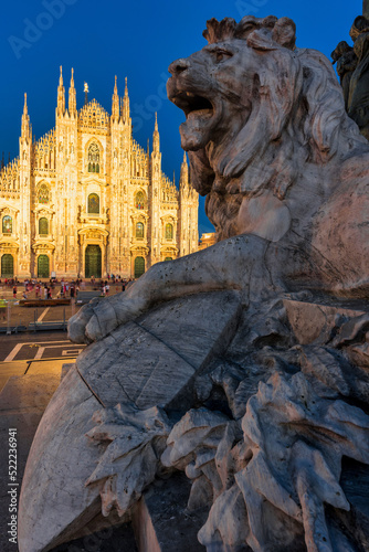 Sunset Scene of The ornate gothic facade, soaring spires and magnificent marble towers of the Duomo, Milan's monumental cathedral under big blue Lombardy skies