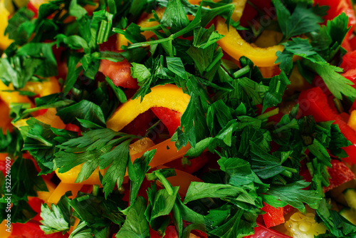 Juicy salad of seasonal summer vegetables close-up. Tomatoes, cucumbers, bell peppers, parsley. © Aleksei