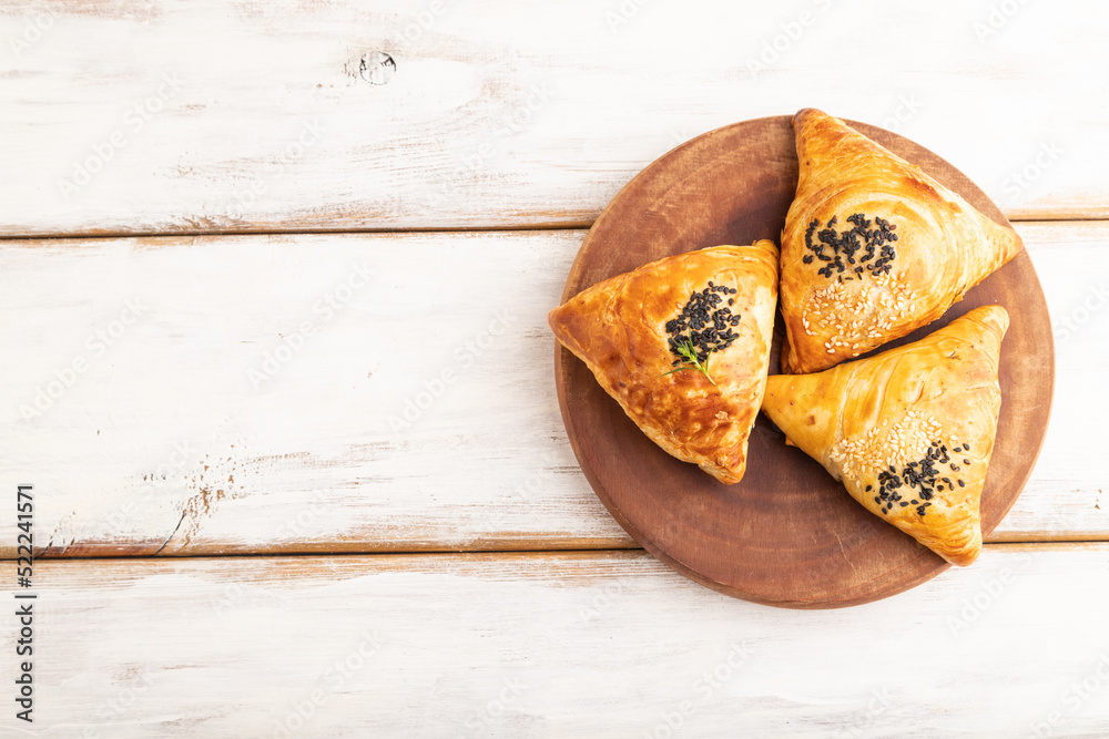 Homemade asian pastry samosa on white wooden. top view, copy space.
