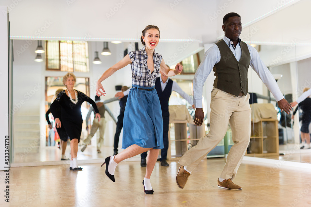 Fototapeta premium Woman with african man practising charleston dancing