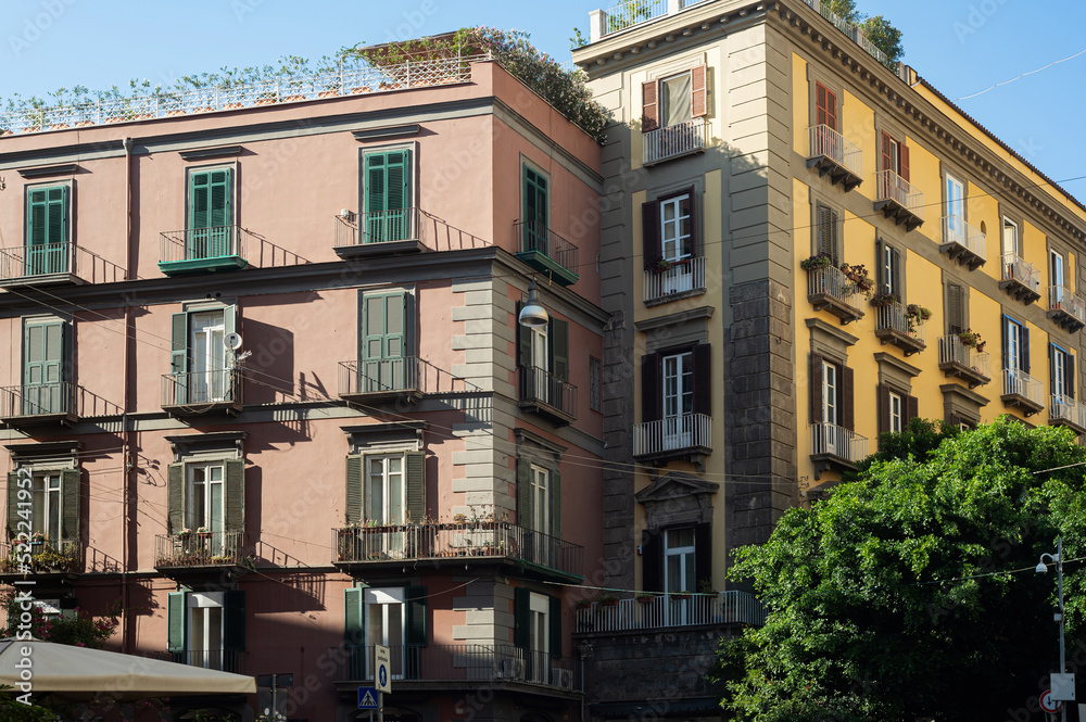 Fototapeta premium Residential areas of Naples, Italy. Beautiful various balconies on the facades of beautiful houses. Italian architecture. Classic shuttered windows and Balconies in a classic red house.
