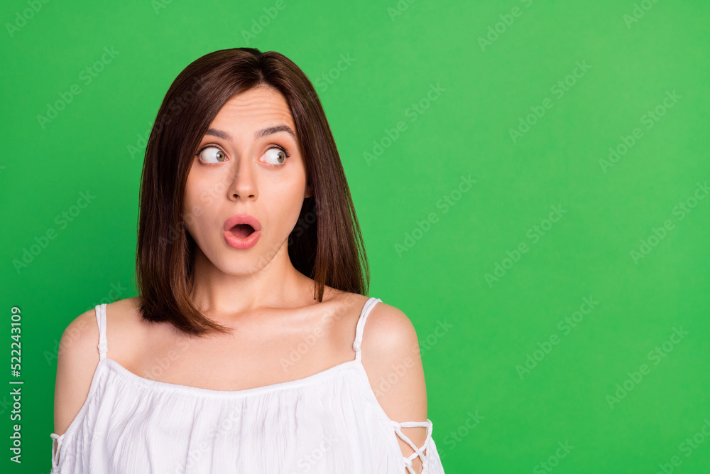 Photo of impressed lady open mouth pouted lips look empty space cant believe isolated on green color background Photo of impressed lady open mouth pouted lips look empty space cant believe isolated on green color background