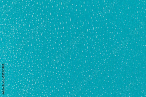 Water drops on blue background. Full frame photo.