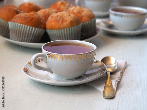 Cup of tea, teaspoon, and cupcake