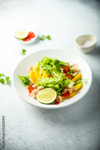 Fresh green salad with shrimps and mango