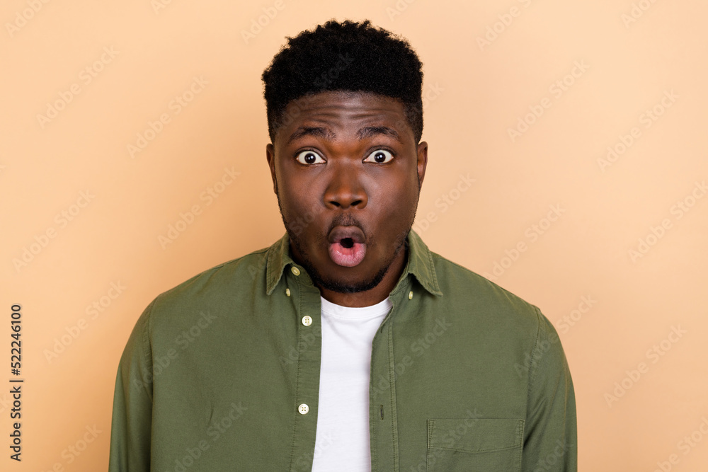 Fototapeta premium Photo of hooray young brunet guy look camera wear khaki shirt isolated on beige color background