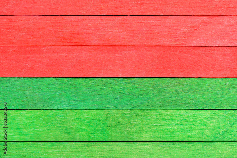 Bright colorful texture of wooden boards painted in green and red Christmas colors. Wooden wall with horizontal boards in two colors. Colored wooden planks backdrop. Bright colorful texture of wooden boards painted in green and red Christmas colors. Wooden wall with horizontal boards in two colors. Colored wooden planks backdrop.
