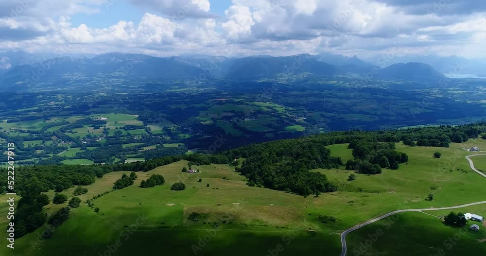 Aerial shot of green countryside, grass fields, forest and mountain Aerial shot of green countryside, grass fields, forest and mountain