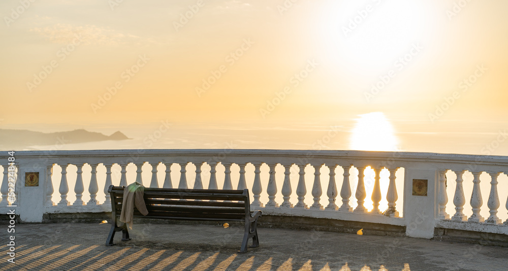 romantic bench on the beach at sunset with a view