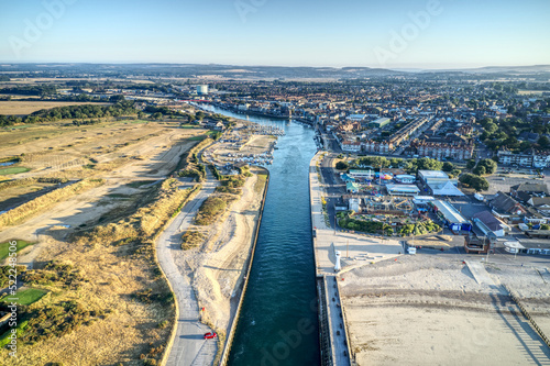 Aerial view of the River Arun and Littlehampton plus the golf course during the dry and hot summer of 2022 with some fairways dried out from the lack of rain. photo