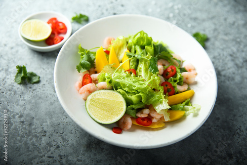 Fresh green salad with shrimps and mango