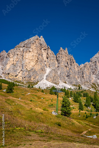 Cover page with magical granite Dolomite peaks and alpine forests of Pizes da Cir, Passo Gardena, Colfosco at blue sky and sunny day, South Tyrol, Alps, Italy.