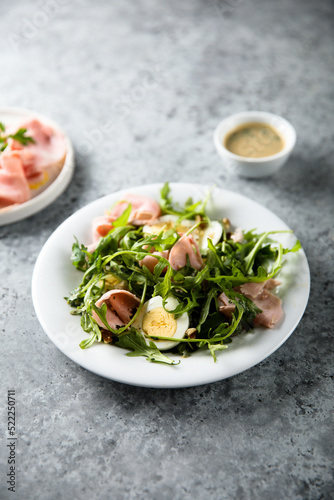 Arugula salad with ham and egg