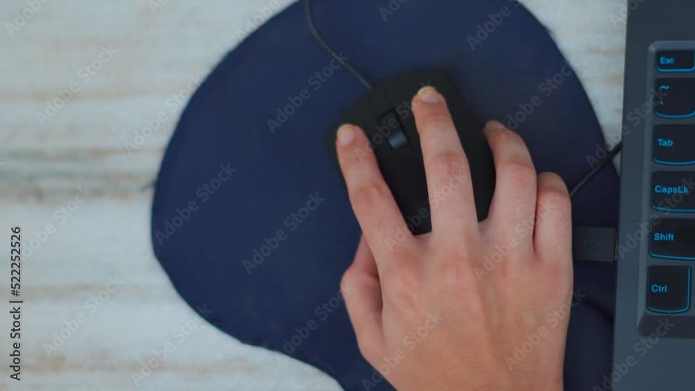 Close up of A woman's hand works with a mouse and keyboard manipulator. Indian Woman using a black computer mouse. Woman working at home on laptop Close up of A woman's hand works with a mouse and keyboard manipulator. Indian Woman using a black computer mouse. Woman working at home on laptop