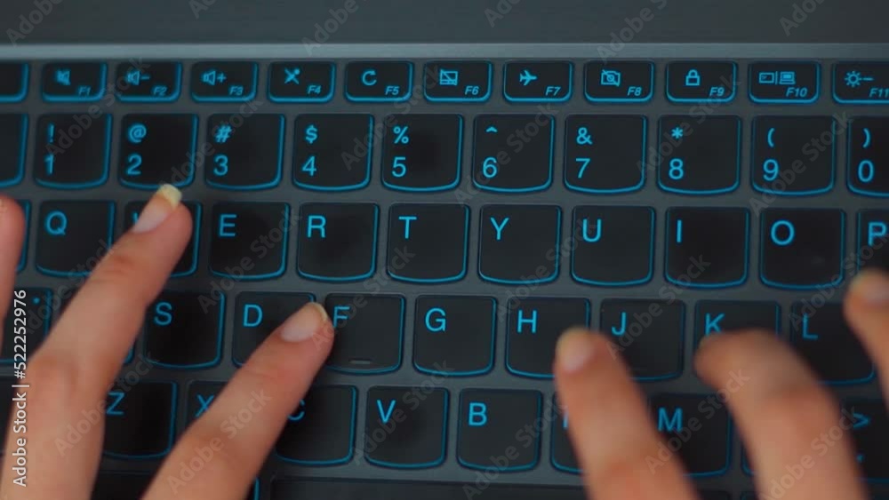Directly above view of female hands typing on laptop keyboard. Woman working from home. Top view of young busy worker typing on laptop