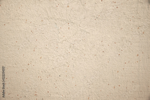 Light background of plaster of house with small dots.