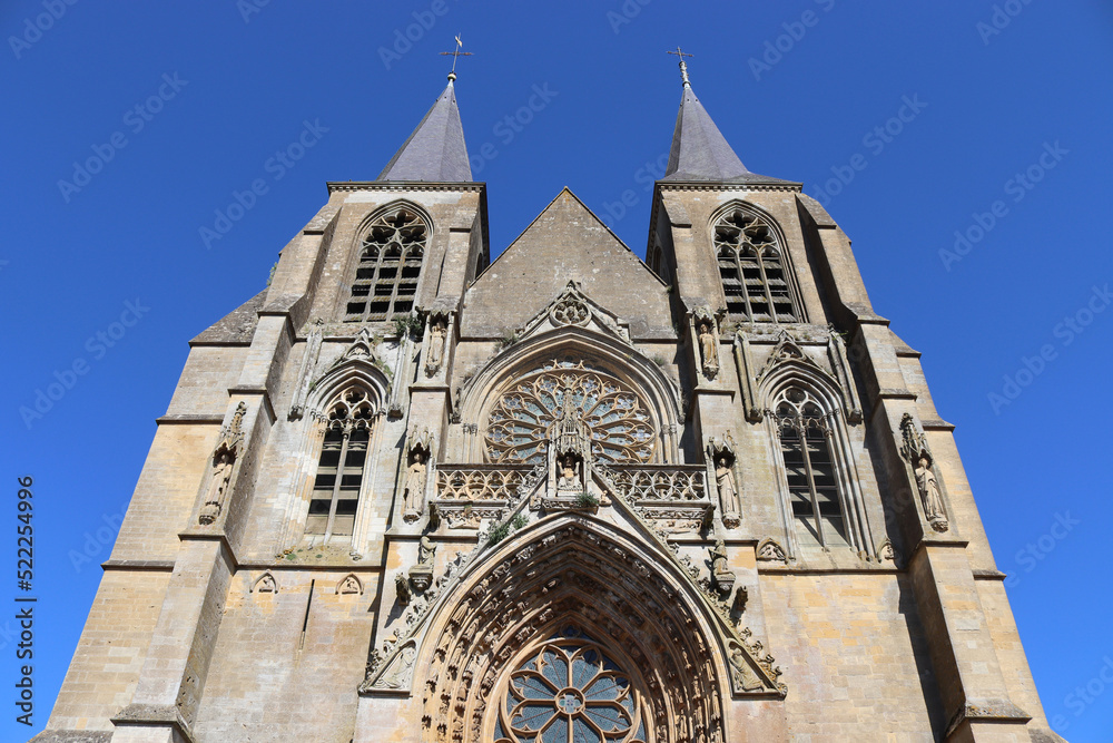 Beautiful view of the exterior facade of the gothic style Basilica of Notre Dame of Avioth. Located in the region of Grand Est France, summer view with clear sky.