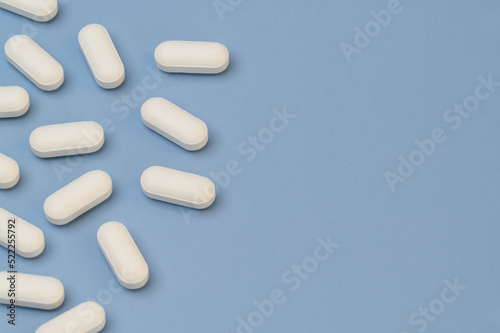 Vitamins tablets supplements on Blue background