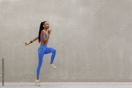 Fit woman exercising outdoors. Healthy young female athlete doing fitness workout.