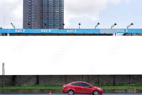 A mockup of a full horizontal billboard. Large billboards in the city during daytime with large buildings in the background.