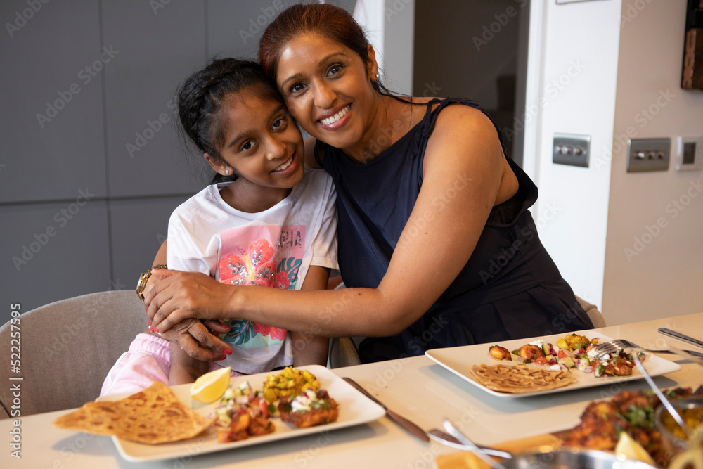 UK, London, Portrait of mother and daughter enjoying dinner at home
