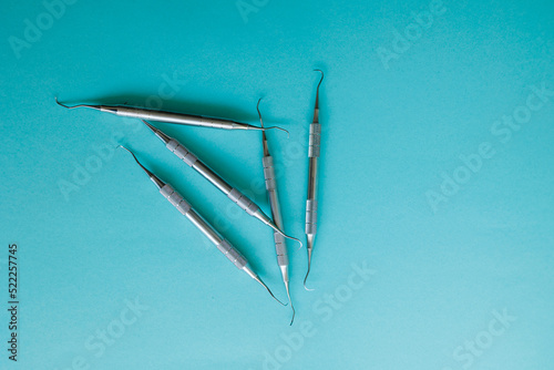 Periodontal scalers on the light blue background photo