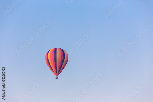 Colorful hot air balloon flying in the bright blue sky © wannasak