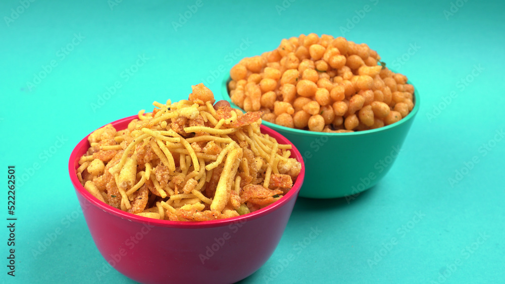 Indian Snacks, Traditional Indian deep fried salty dish called chivda or mixture or farsan made of gram flour and mixed with dry fruits and roasted nuts with salt, pepper, pulses, spice and green peas Indian Snacks, Traditional Indian deep fried salty dish called chivda or mixture or farsan made of gram flour and mixed with dry fruits and roasted nuts with salt, pepper, pulses, spice and green peas