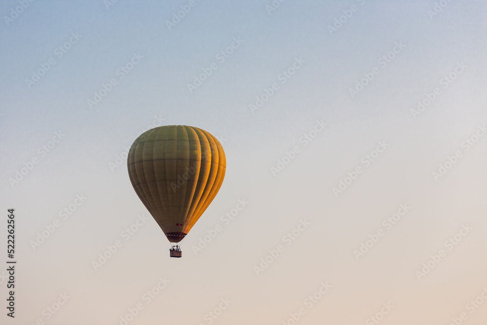 Colorful hot air balloon flying in the bright blue sky Colorful hot air balloon flying in the bright blue sky