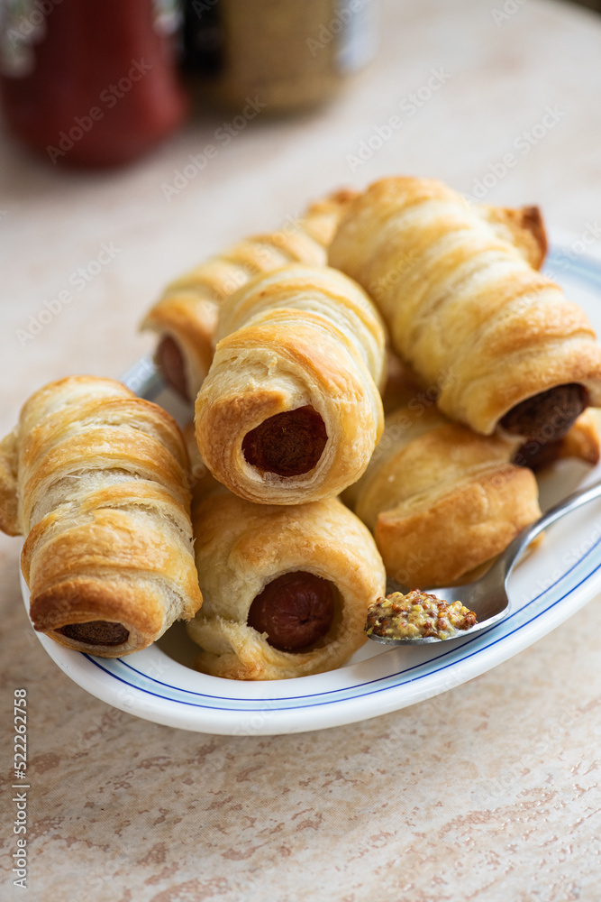 Pigs in a blanket - mini sausage roll on a plate.