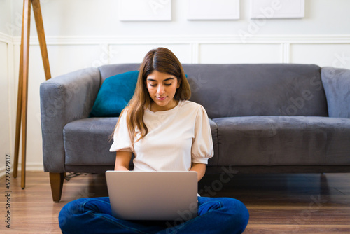 Young woman doing telecommute work and using the laptop