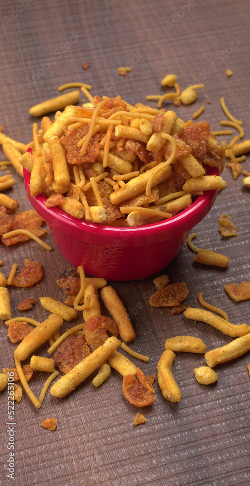 Indian Snacks, Traditional Indian deep fried salty dish called chivda or mixture or farsan made of gram flour and mixed with dry fruits and roasted nuts with salt, pepper, pulses, spice and green peas