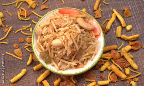 Indian Snacks, Traditional Indian deep fried salty dish called chivda or mixture or farsan made of gram flour and mixed with dry fruits and roasted nuts with salt, pepper, pulses, spice and green peas photo