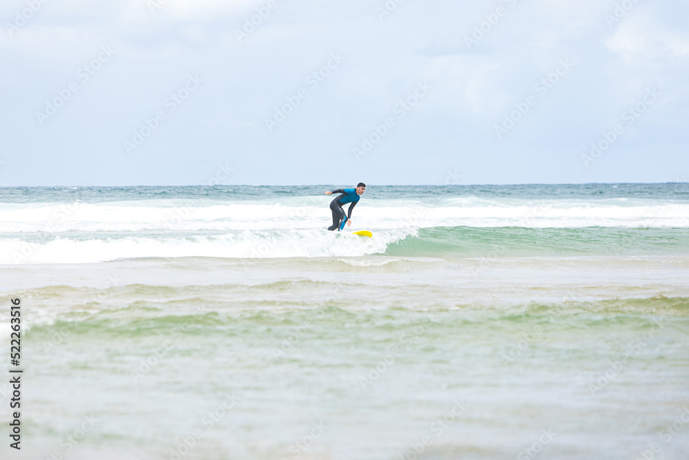 Anonymous man riding wave on surfboard in ocean Anonymous man riding wave on surfboard in ocean