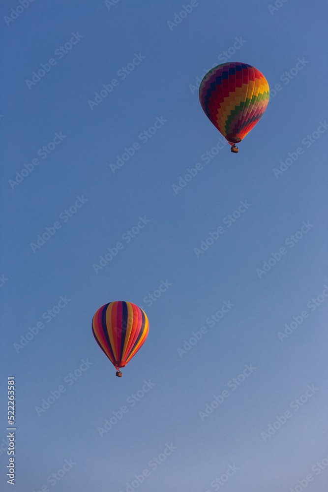 Obraz premium Two Hot Air Balloons against blue sky