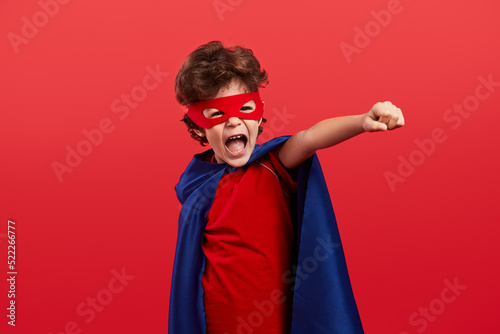 Little superhero screaming and clenching fist