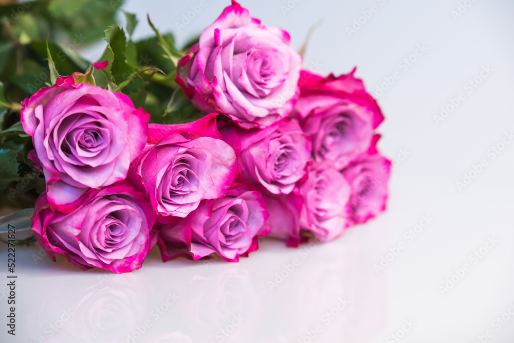 Bouquet of purple roses on white background. Flower background. Mothers Day, Wedding and Birthday concept.