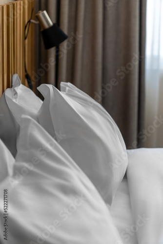 hotel room double bed with white linens and mountain view