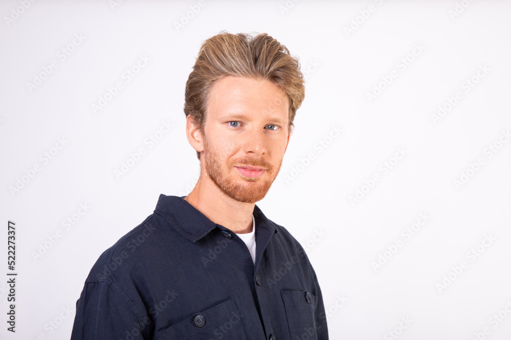 Portrait of successful young man looking at camera and smiling. Bearded man wearing T-shirt and black shirt standing with positive expression. Successful man concept Portrait of successful young man looking at camera and smiling. Bearded man wearing T-shirt and black shirt standing with positive expression. Successful man concept