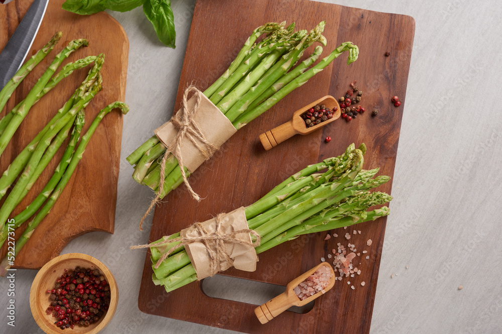 banches of fresh green asparagus on wooden background, fresh asparagus on wooden. group of Fresh asparagus on the wood background, raw vegetable food for health cook. and spices. Healthy food. banches of fresh green asparagus on wooden background, fresh asparagus on wooden. group of Fresh asparagus on the wood background, raw vegetable food for health cook. and spices. Healthy food.