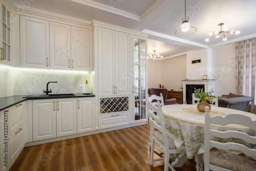 White luxiry modern classic kitchen furniture with dining table photo