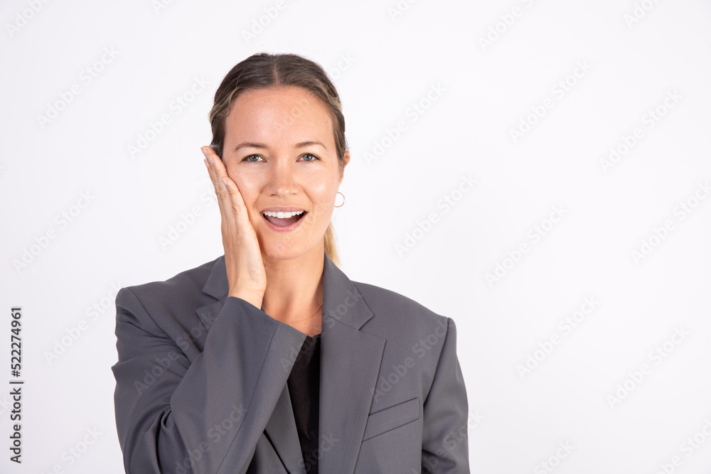 Portrait of confused young businesswoman touching face. Caucasian woman wearing gray suit coat forgetting something or making mistake. Problem or confusion concept Portrait of confused young businesswoman touching face. Caucasian woman wearing gray suit coat forgetting something or making mistake. Problem or confusion concept