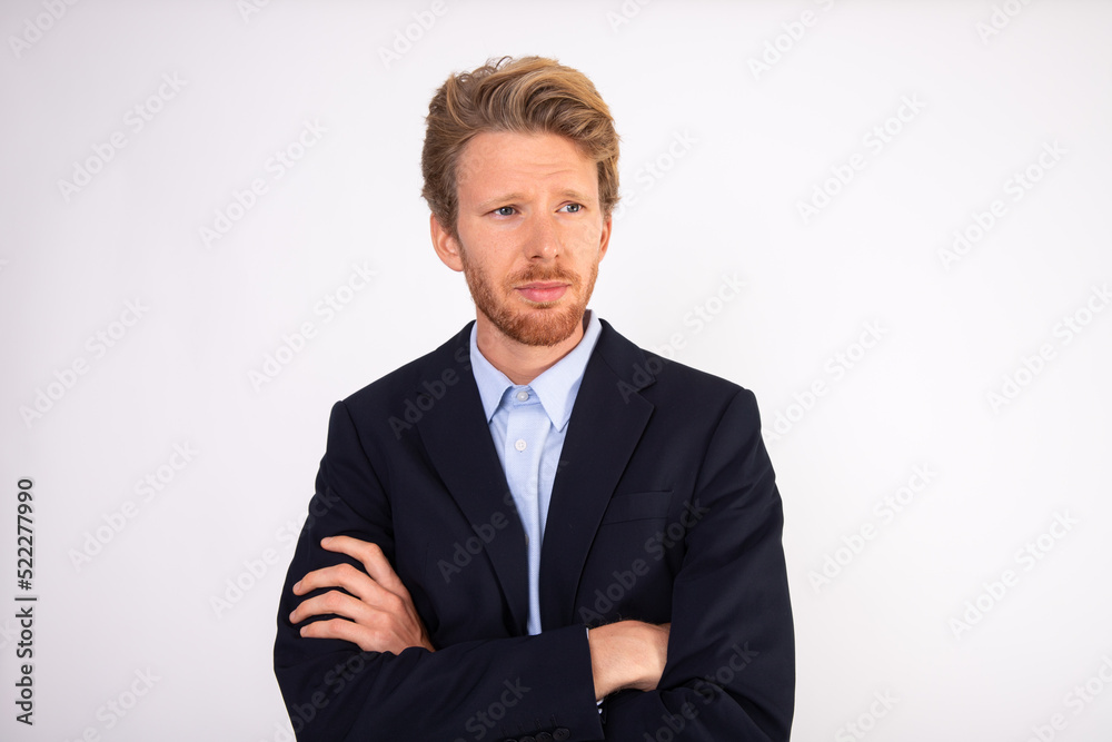 Portrait of serious young manager standing with arms crossed. Caucasian businessman wearing blue shirt and black suit coat standing with calm expression. Business concept Portrait of serious young manager standing with arms crossed. Caucasian businessman wearing blue shirt and black suit coat standing with calm expression. Business concept