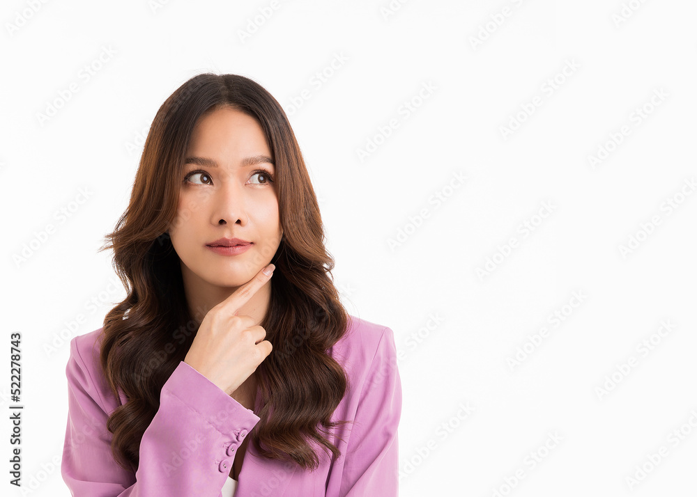 Asian woman with long hair, wearing a suit, thinking and looking at white empty space. Asian woman with long hair, wearing a suit, thinking and looking at white empty space.
