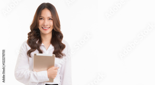 Asian business woman, long hair, wearing a white shirt, holding a tablet, standing on a white background.