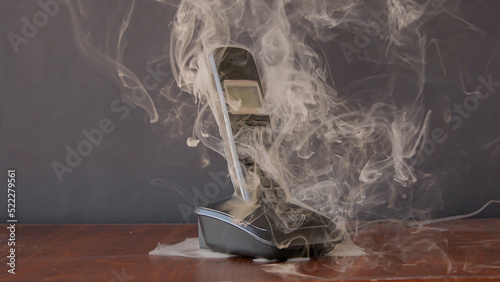 Canvas Print the radiotelephone smokes and burns, sparks fly, a short circuit in household electrical appliances and household appliances