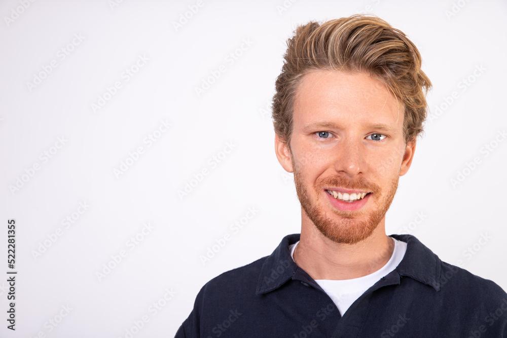 Close-up of happy face of young Caucasian man. Portrait of bearded man looking at camera and smiling. Success and happiness concept Close-up of happy face of young Caucasian man. Portrait of bearded man looking at camera and smiling. Success and happiness concept