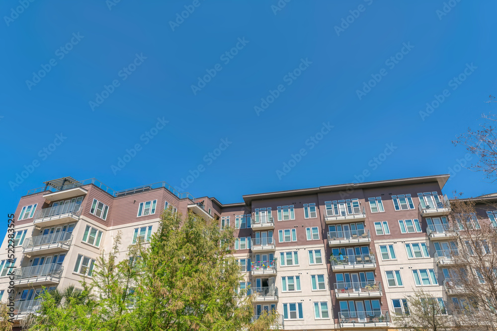 Facade of mid-rise residential building with beige and brown wall at San Antonio, Texas