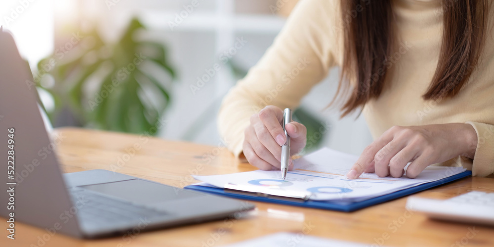 Business woman calculating domestic expenses involved in financial paperwork indoors, focused lady managing monthly banking payments summarizing utility bills and taxes at home Business woman calculating domestic expenses involved in financial paperwork indoors, focused lady managing monthly banking payments summarizing utility bills and taxes at home