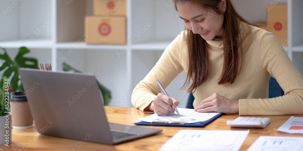 Portrait of Starting small businesses SME owners female entrepreneurs working, box and check online orders to prepare to pack the boxes, sell to customers, sme business ideas online. Portrait of Starting small businesses SME owners female entrepreneurs working, box and check online orders to prepare to pack the boxes, sell to customers, sme business ideas online.